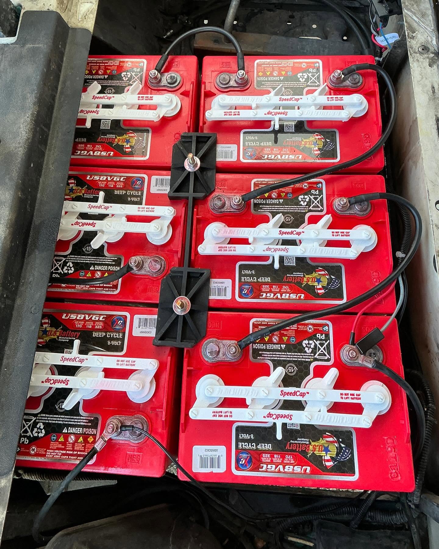Clean golf cart battery compartment after battery service at Arizona Golf Cart Repair